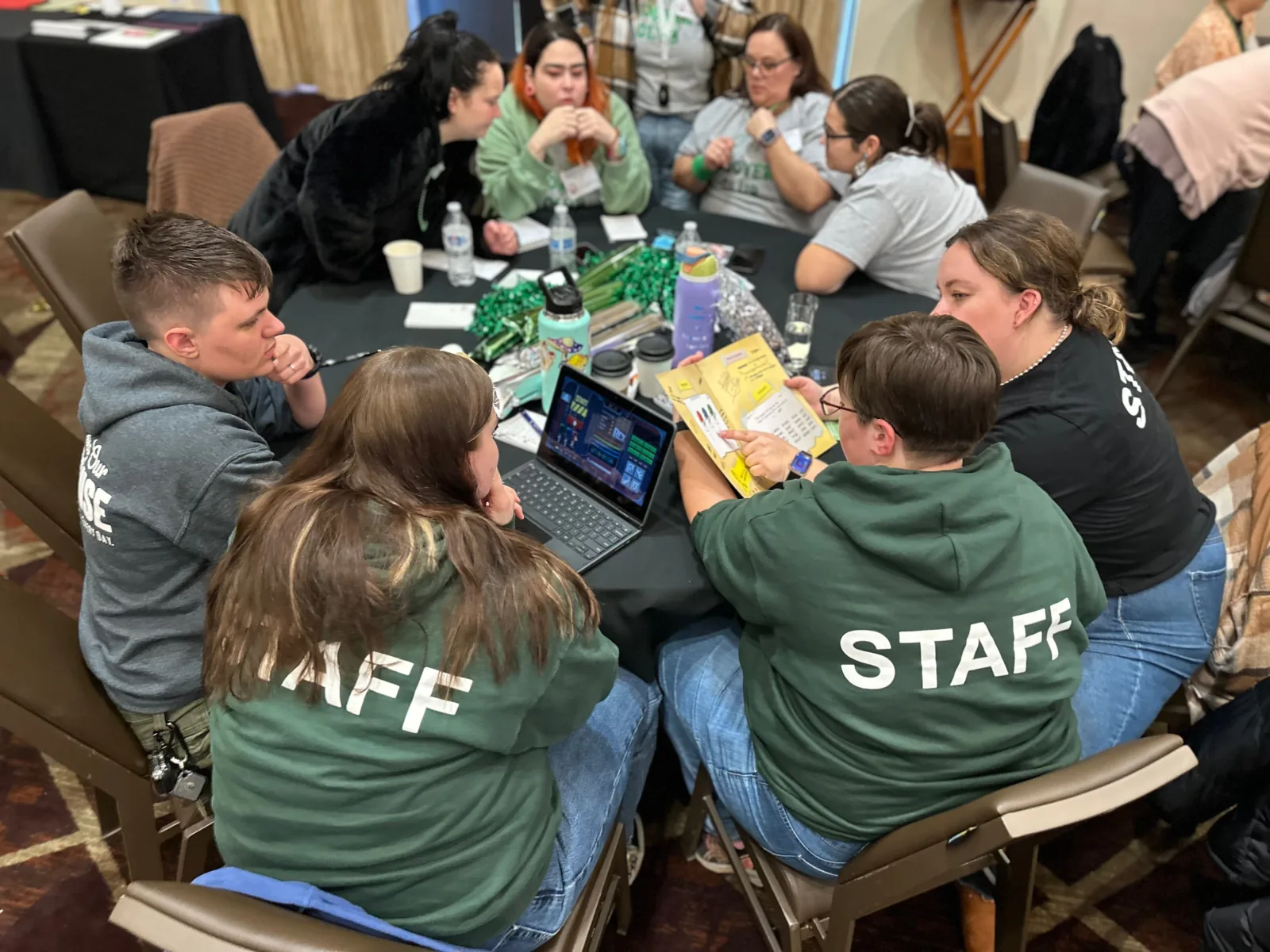 A team racing an UNLOCK challenge with digital and physical pieces